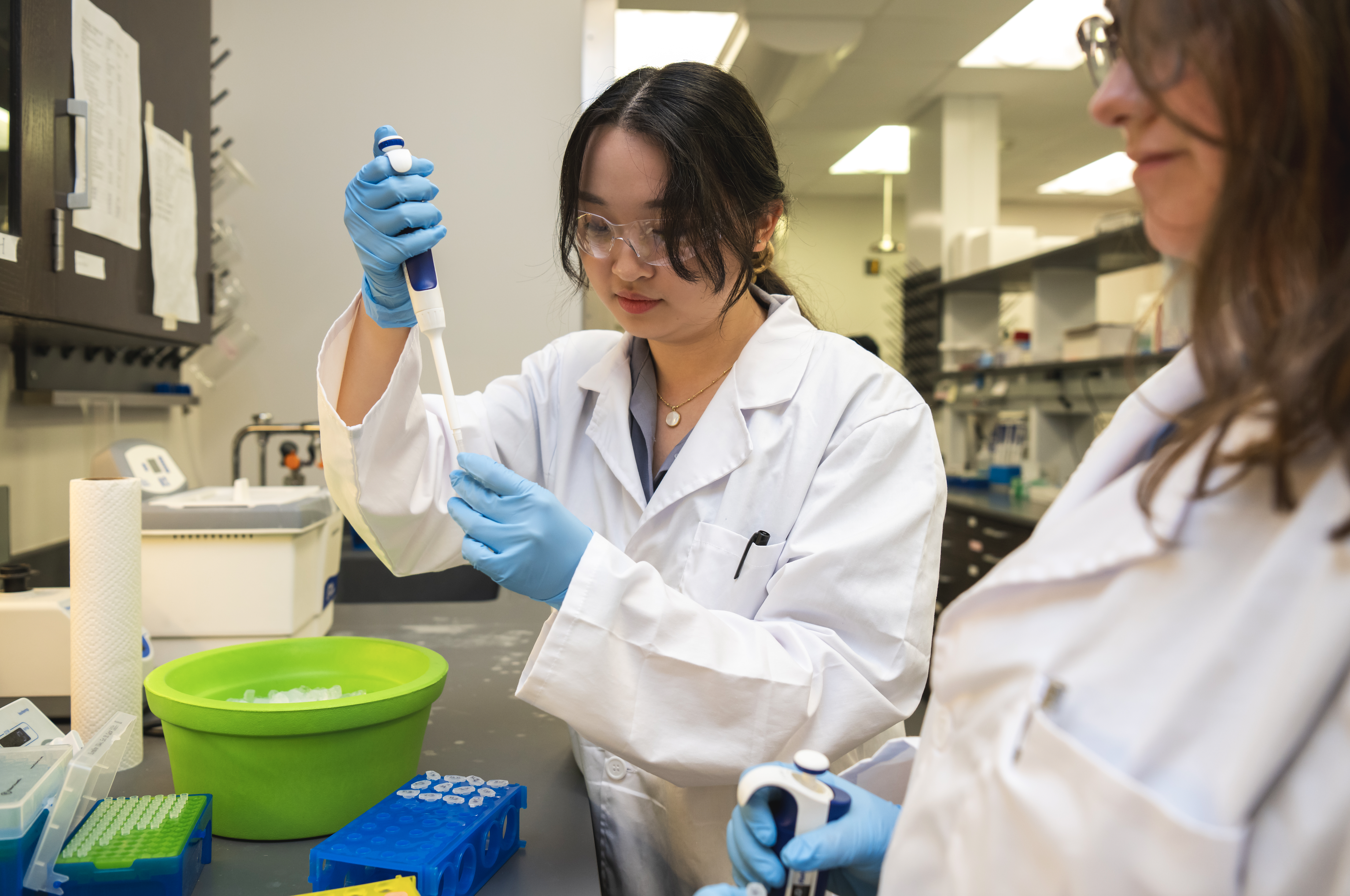 Woman pipetting in a lab setting