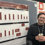 Image of Adam Beam presenting his poster at SPSP 2025