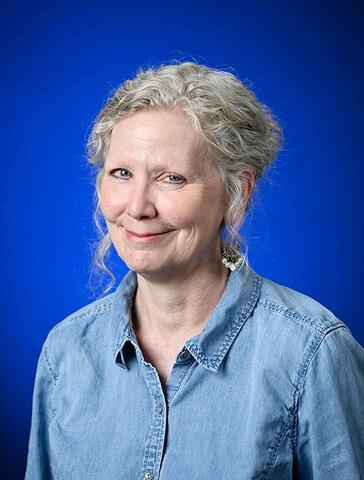 katie mckee formal university portrait with bright blue background