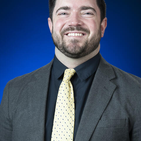A man in suit with yellow tie 