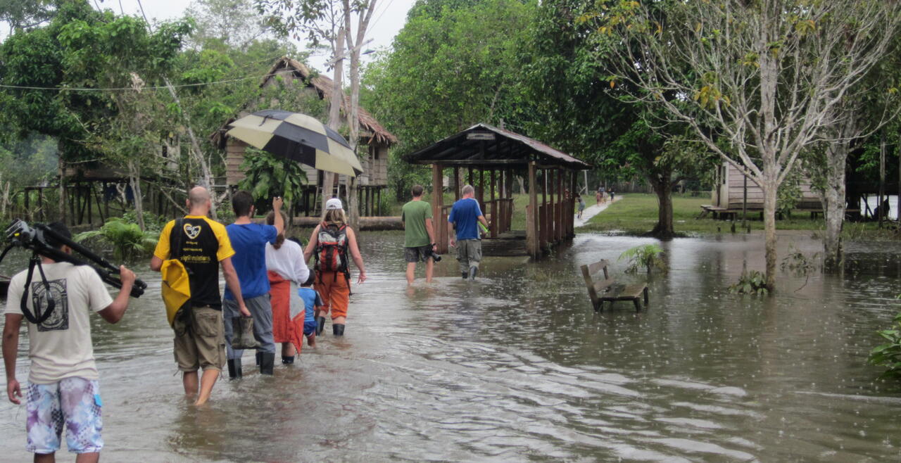 Wading through water in villages in the Peruvian amazon