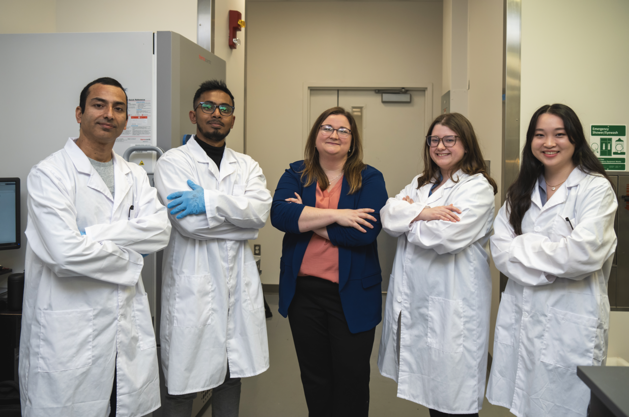 PI and lab students posing in lab