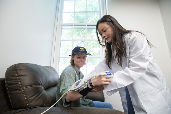 Participant and Experimenter using Figure Cuff Blood pressure machine