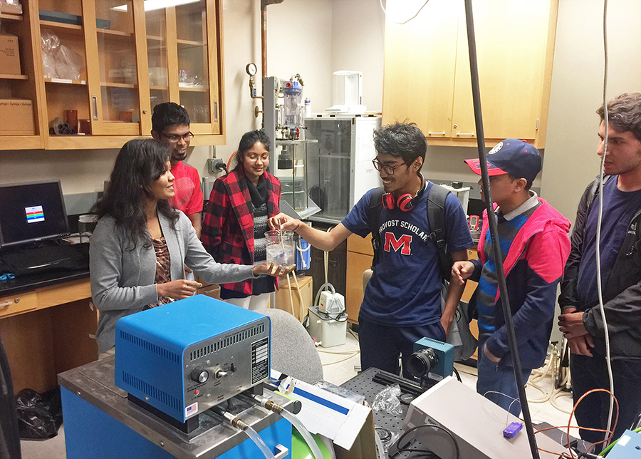 Students discussing an experiment in a lab