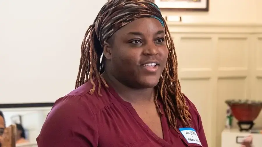 person speaking; turned right slightly and looking to the right of the frame