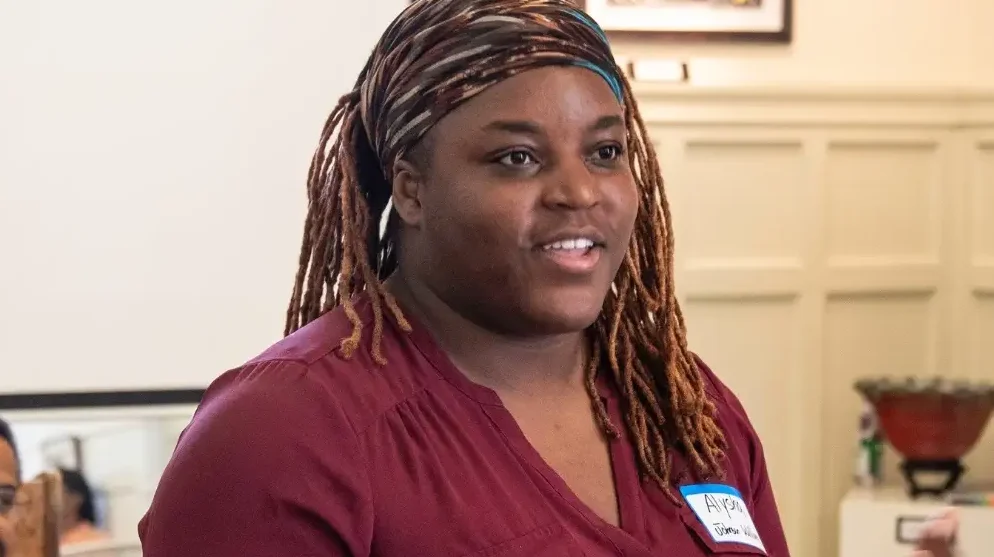 person speaking; turned right slightly and looking to the right of the frame